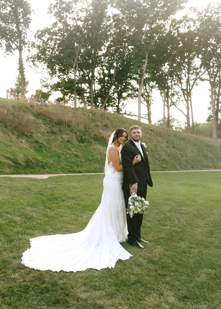 picture of the bride hugging the groom from the back