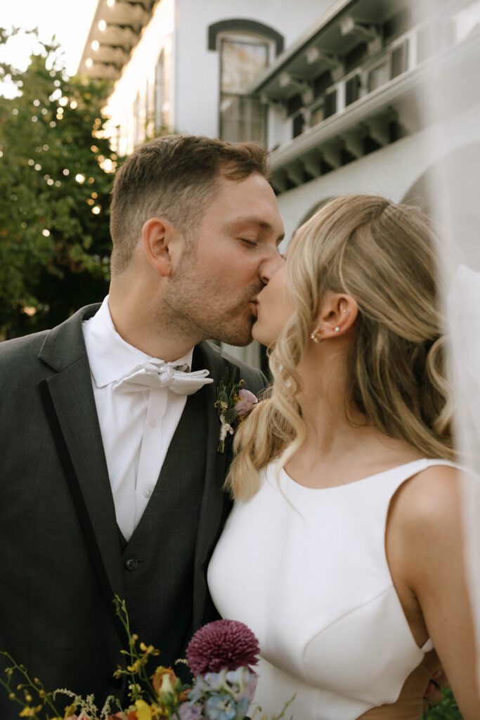 cute picture of the bride and groom kissing during their bridal portraits 