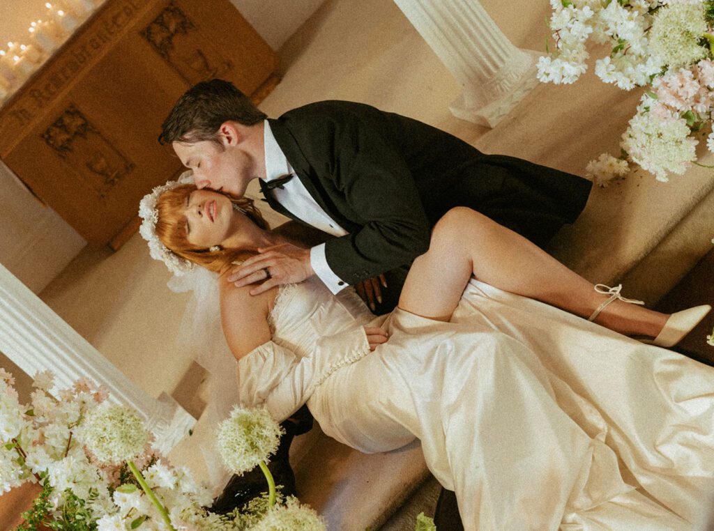 picture of the groom kissing the bride on the cheek