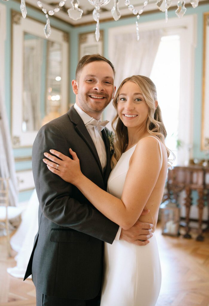 couple smiling at the camera during their bridal portraits 