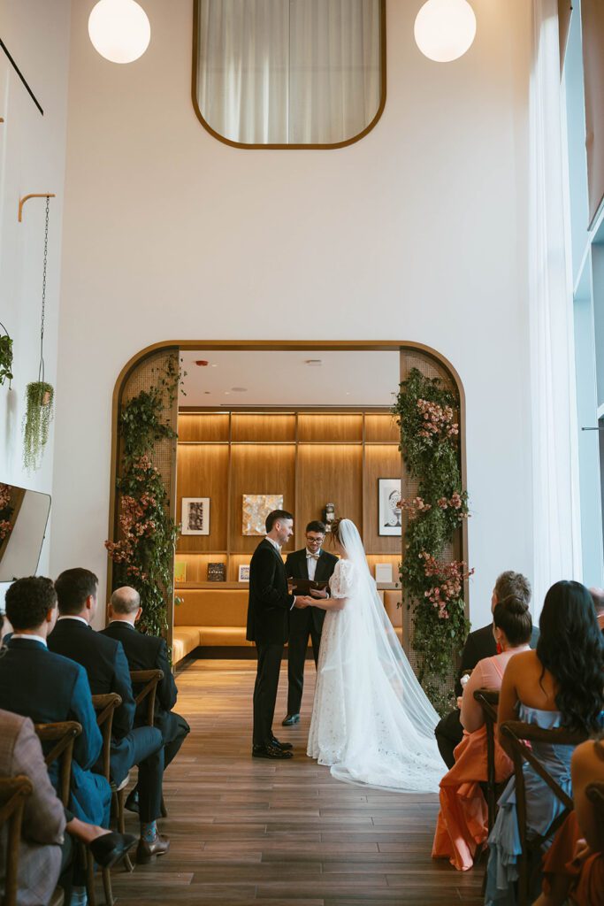 bride and groom holding hands during their wedding ceremony