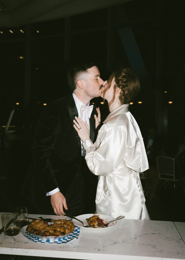 cute picture of the newlyweds kissing at their reception party