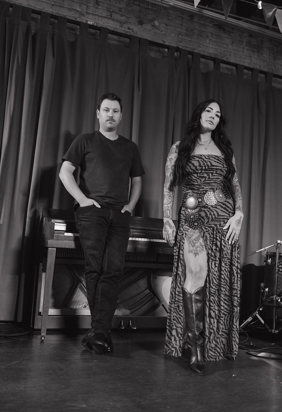 A couple posing in a black and white couples photo inside of a bar