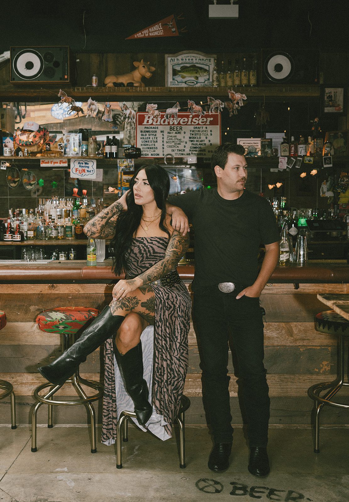 A couple sitting at a bar during a couples photoshoot