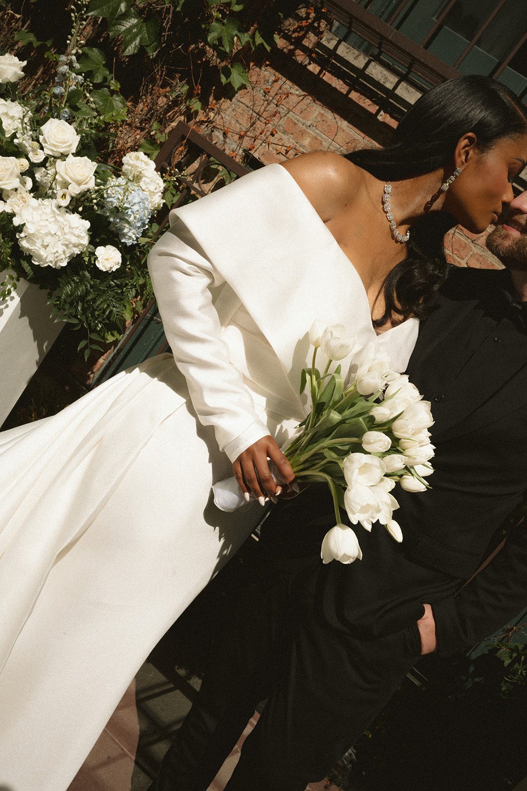 A bride and groom kissing in an editorial wedding photo