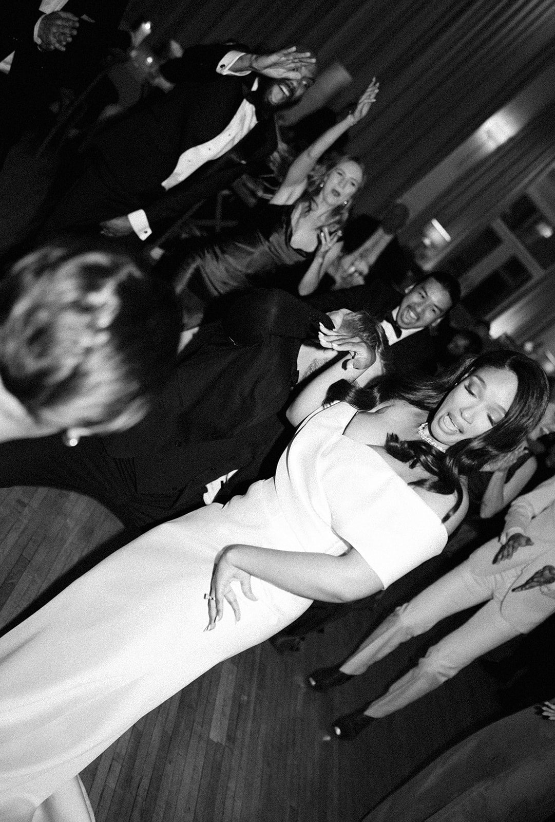 A candid photo of a bride dancing at her wedding reception