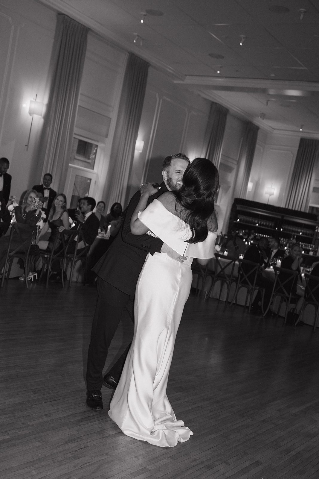 A candid photo of a bride  and groom dancing at their wedding reception