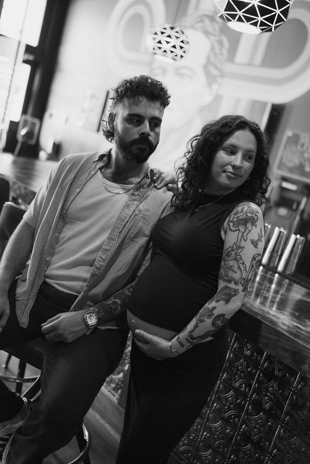 MAternity photoshoot ideas showing taking maternity photos at a bar