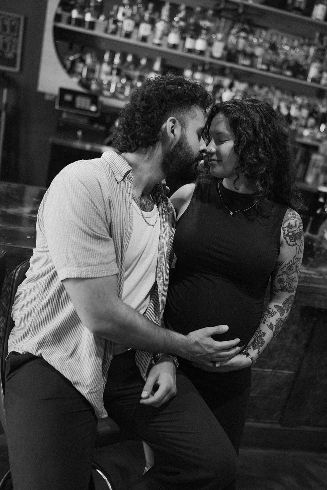 MAternity photoshoot ideas showing taking maternity photos at a bar