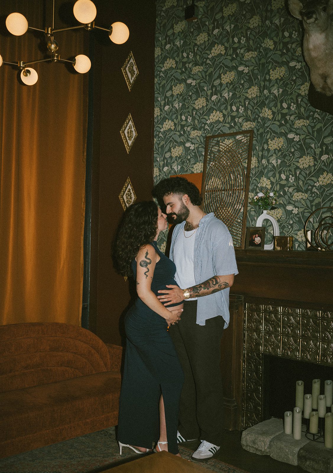 A couple leaning in for a kiss during maternity photos