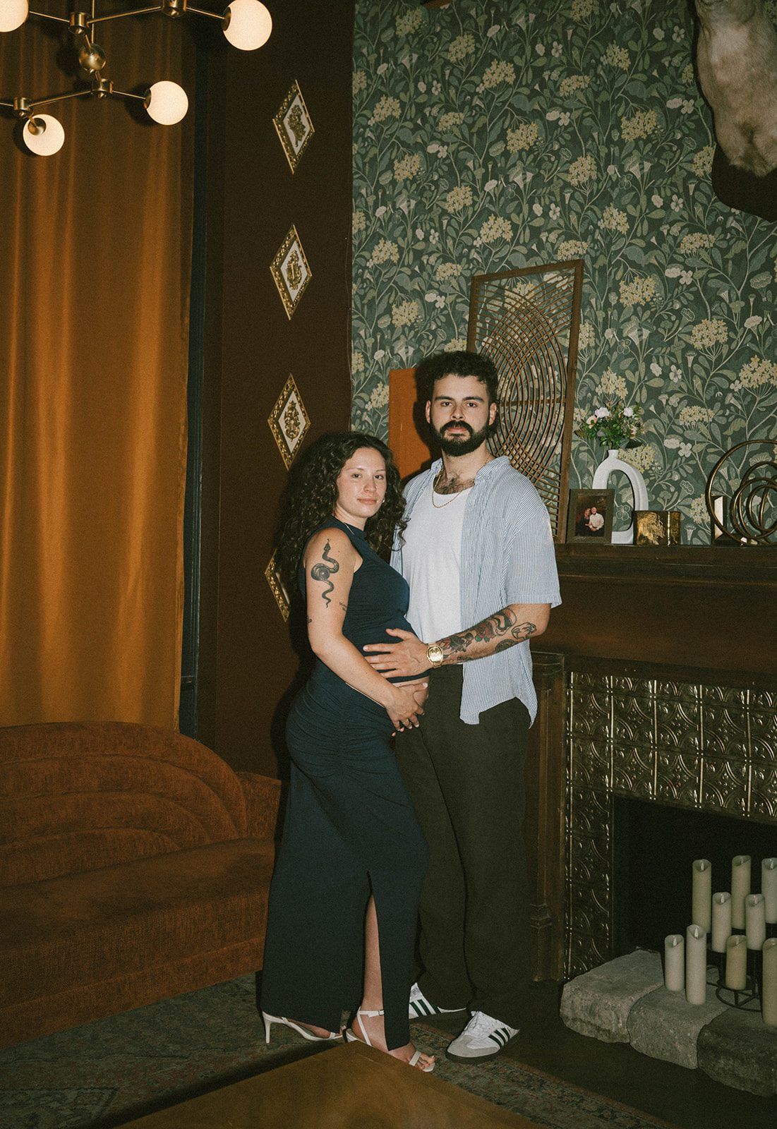 A couple posing in a retro location for maternity photoshoot ideas