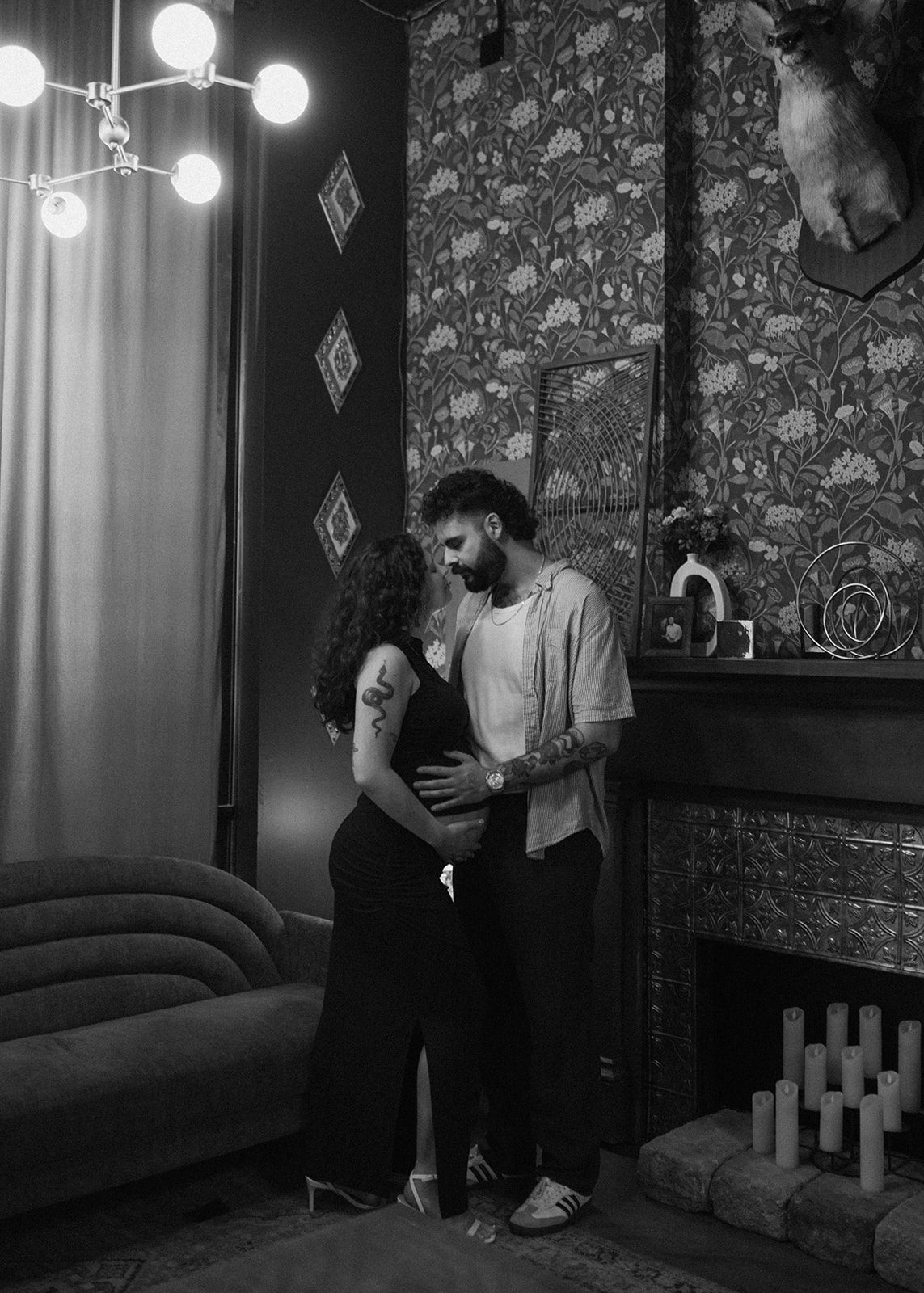 A couple leaning in for a kiss during maternity photos