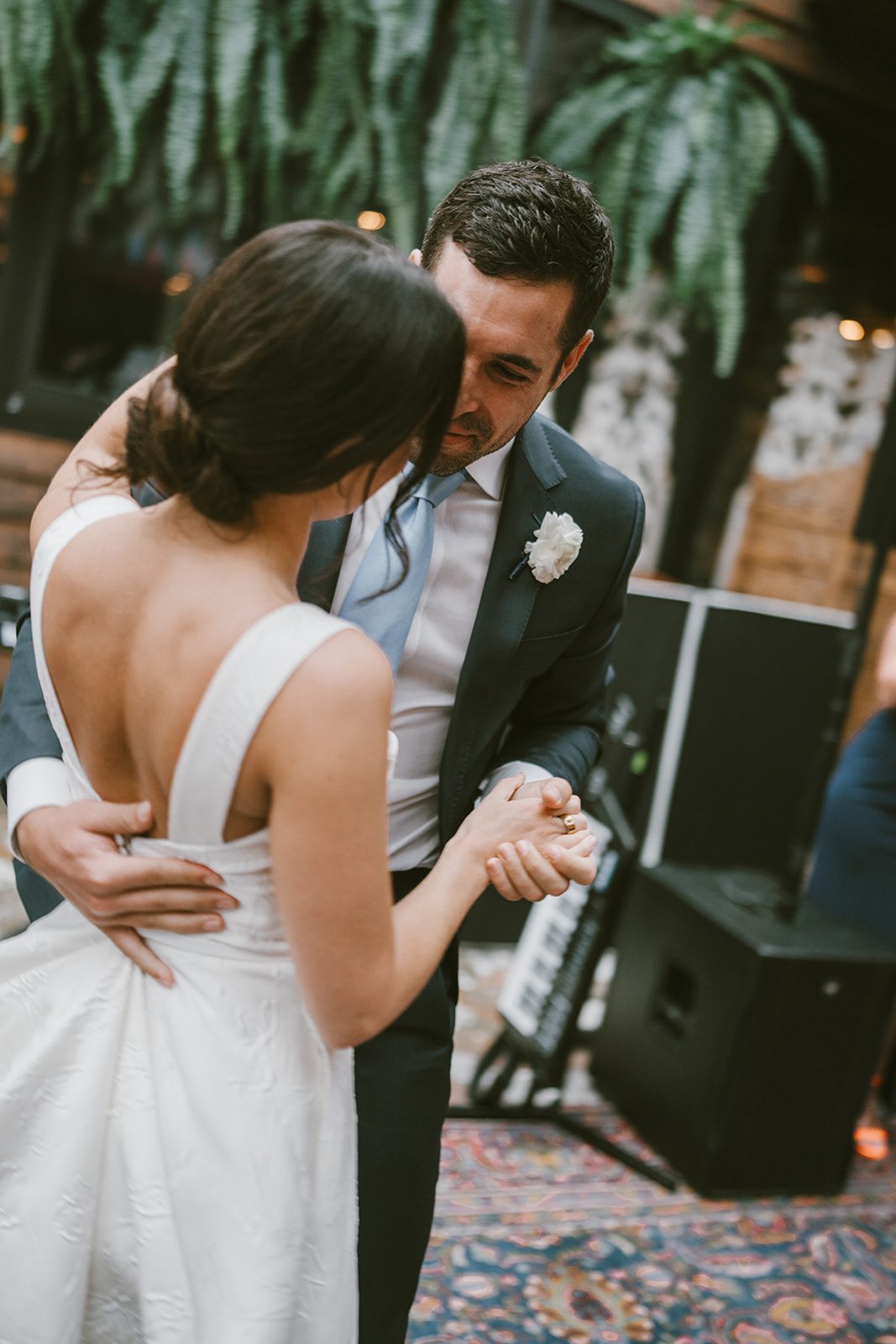 A bride and groom dancing at a restaurant wedding reception at Beatnik West Town