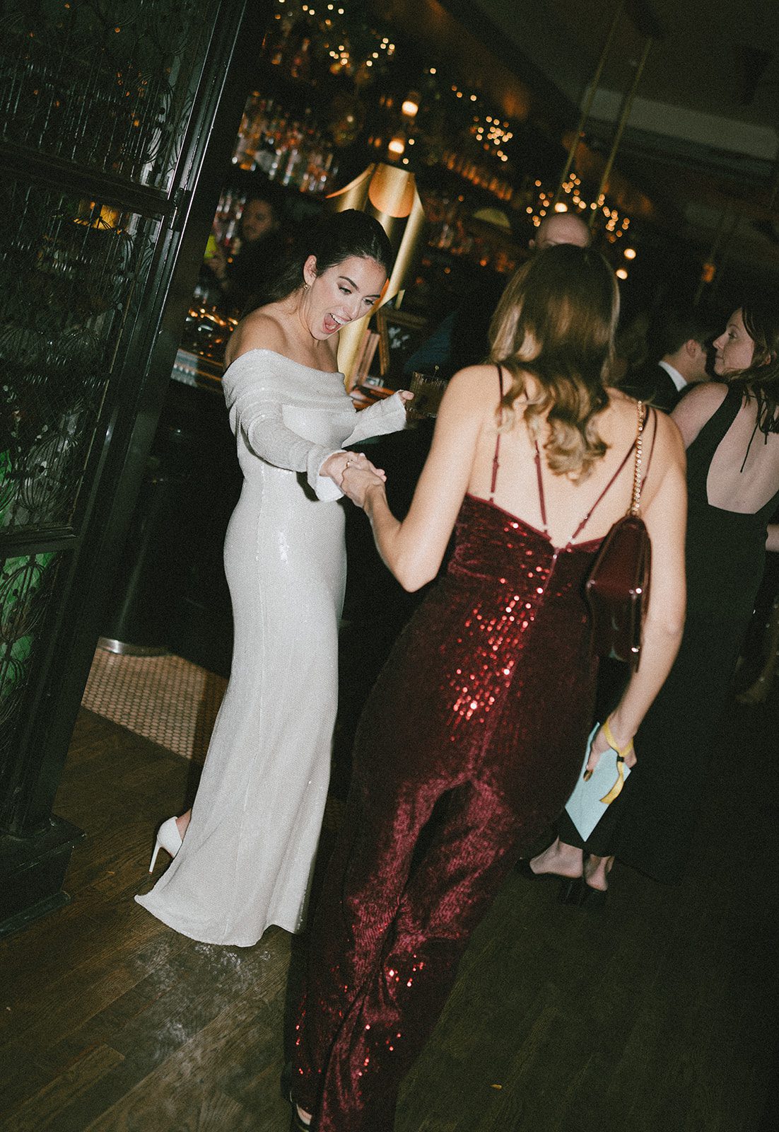 A candid photo of a bride reacting to a wedding guest's outfit