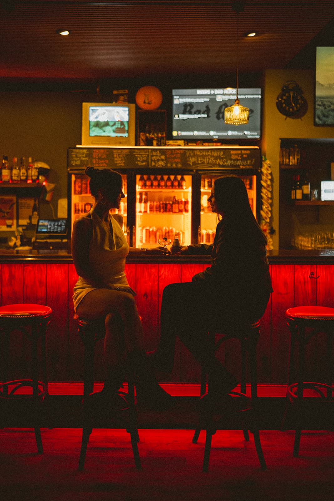 A couple sitting at a bar for their engagement photos