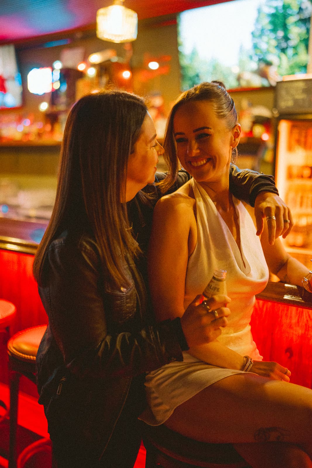 A couple laughing during bar engagement photos