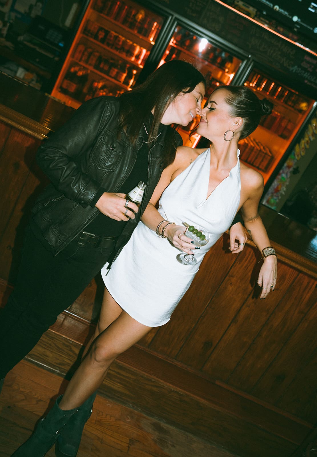 A couple posing for bar engagement photos