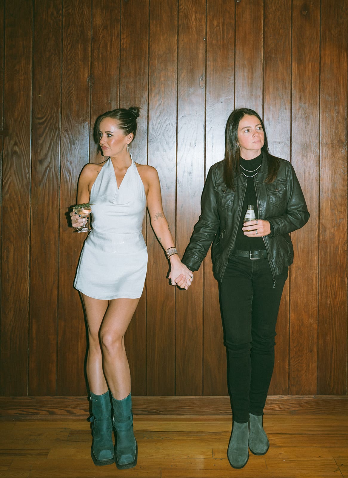 A couple holding hands during bar engagement photoshoot ideas