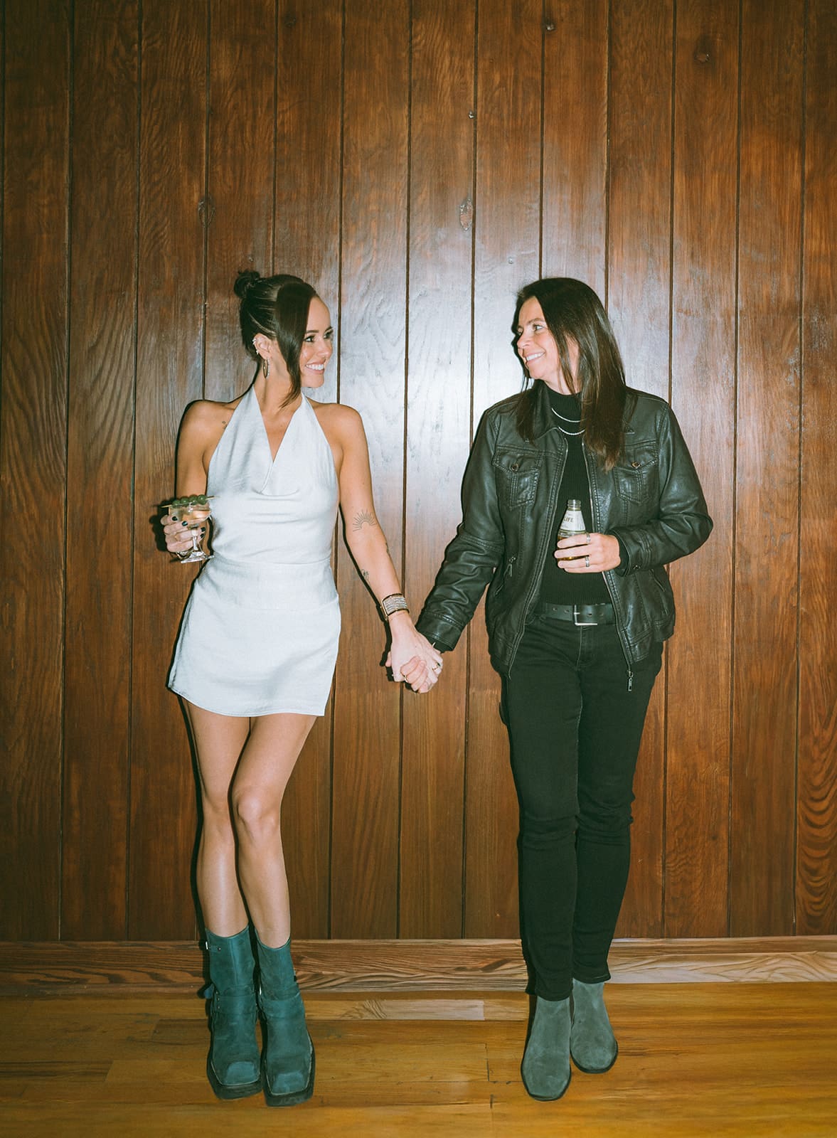 A couple holding hands during bar engagement photoshoot ideas