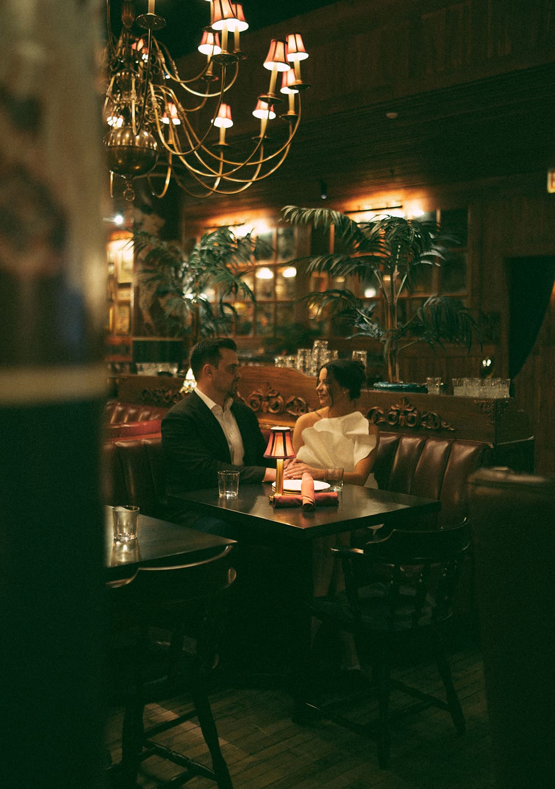 A couple at a booth at their Chicago engagement photo location Trivoli Tavern