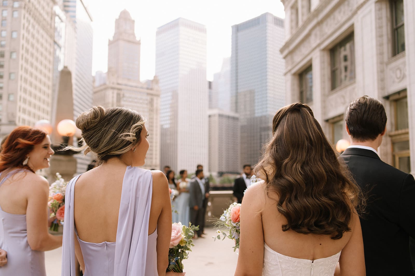 A bride and her wedding party walking to take wedding party photos