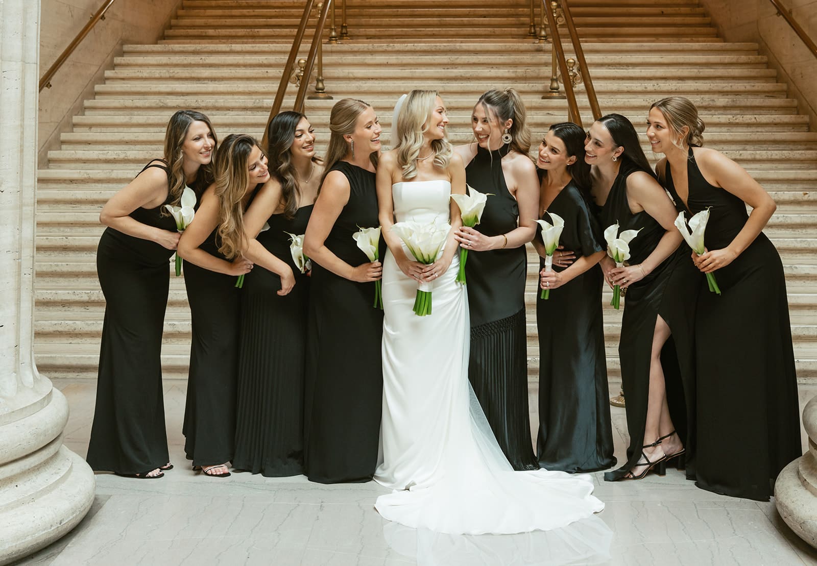 Bridal party photos on the steps in Union Station with bridesmaids in black wedding dresses
