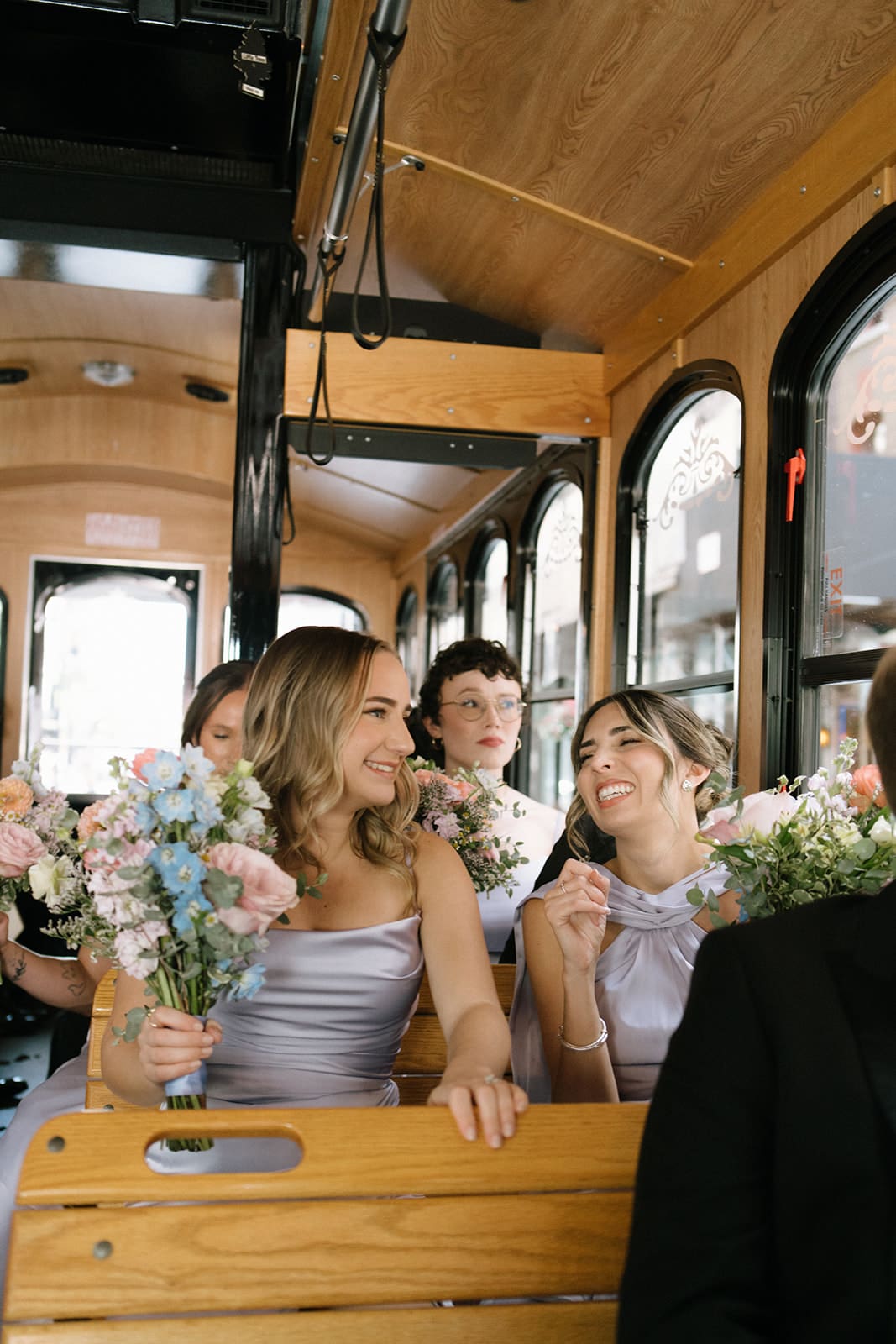 A bridal party on the way to take wedding party photos via trolley