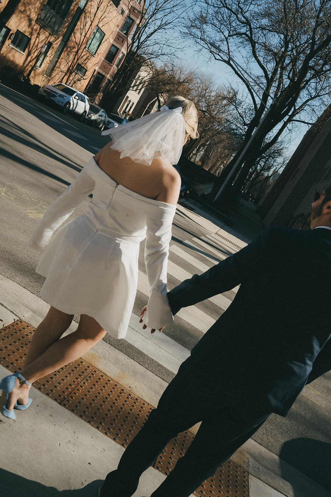 A couple crossing the street during their engagement photos