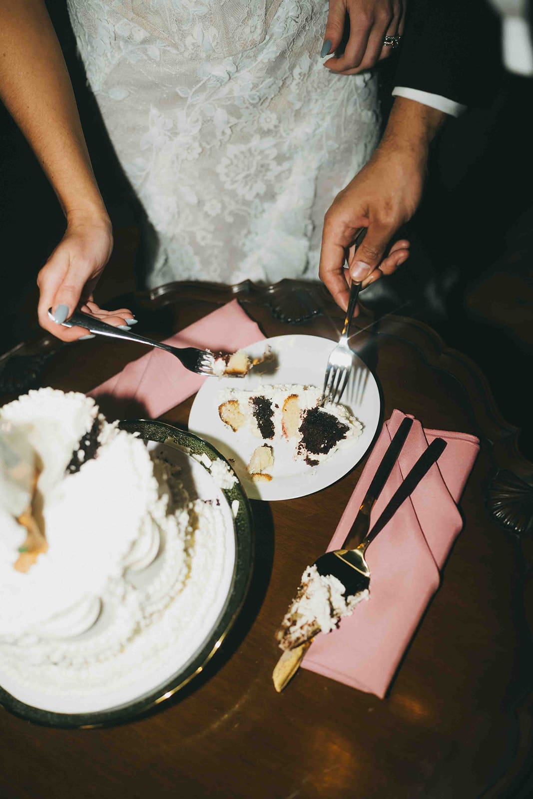 A bride and groom cutting their wedding cake