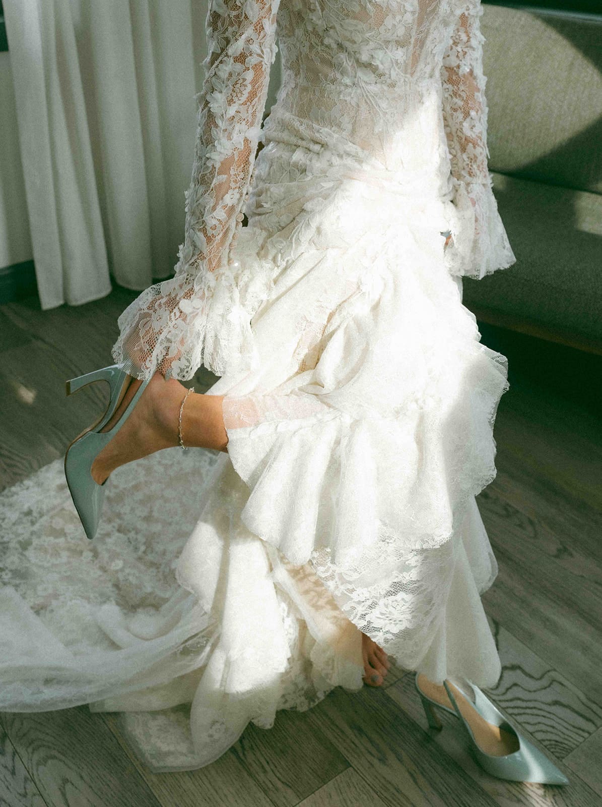 A bride putting on her wedding dress during the getting ready portion of the day of wedding timeline