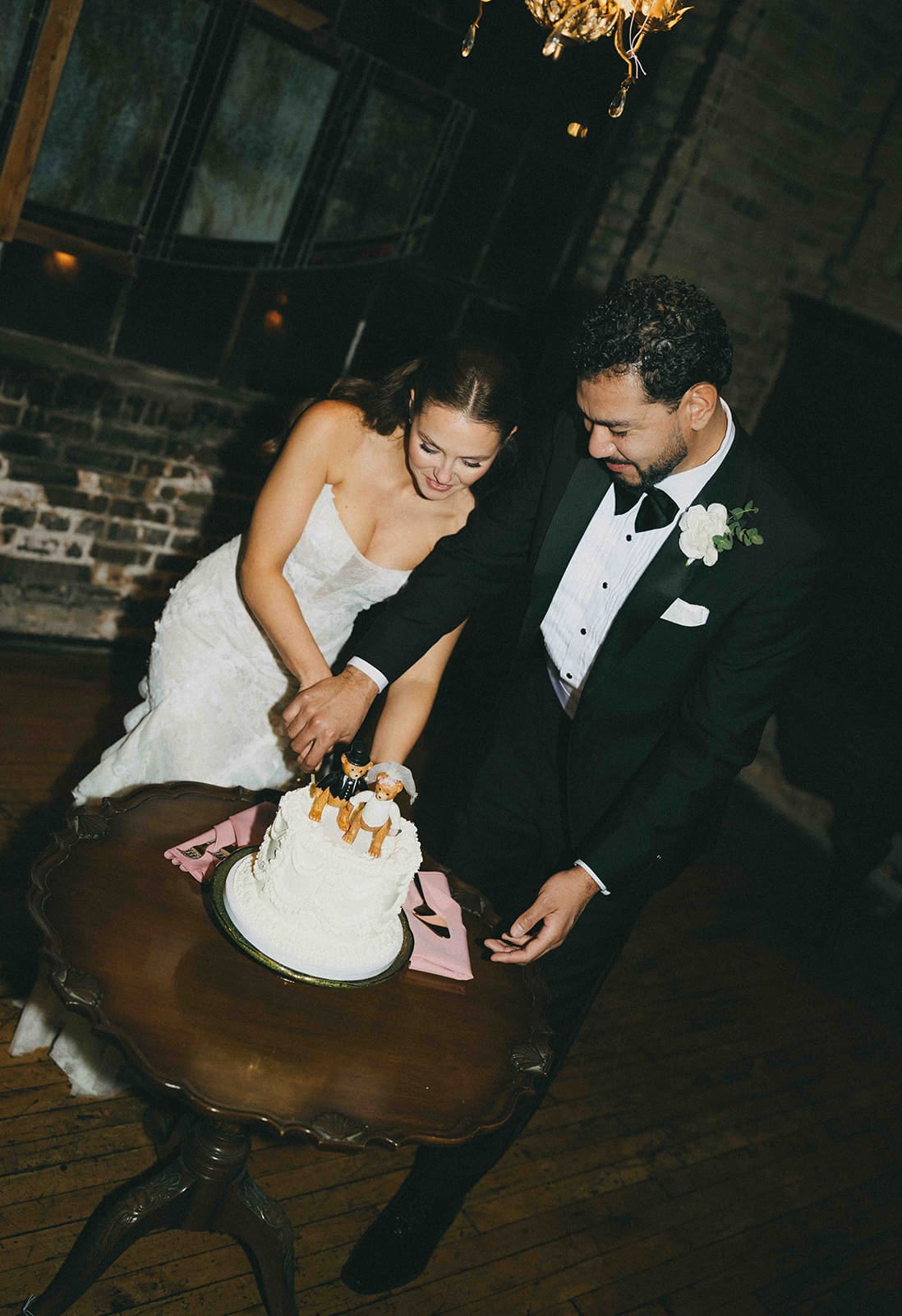 A bride and groom cutting their wedding cake