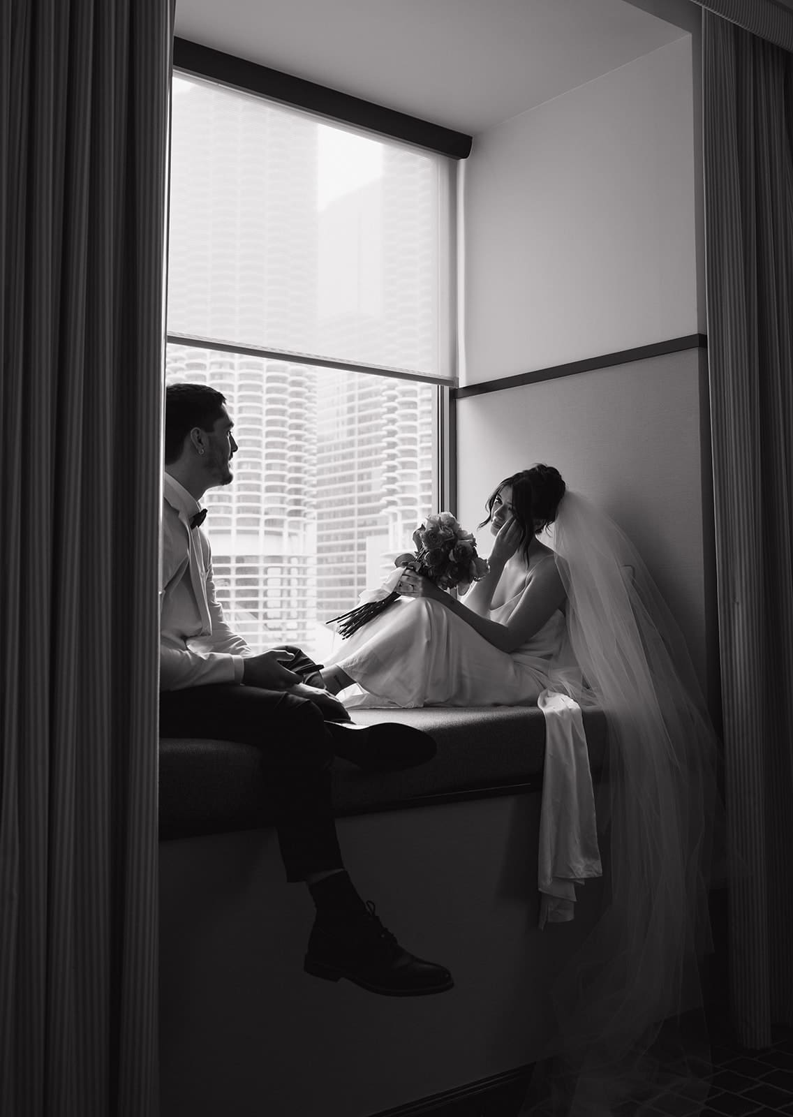 A bride and groom sharing private vows in a hotel room in photos taken by a Chicago wedding photographer