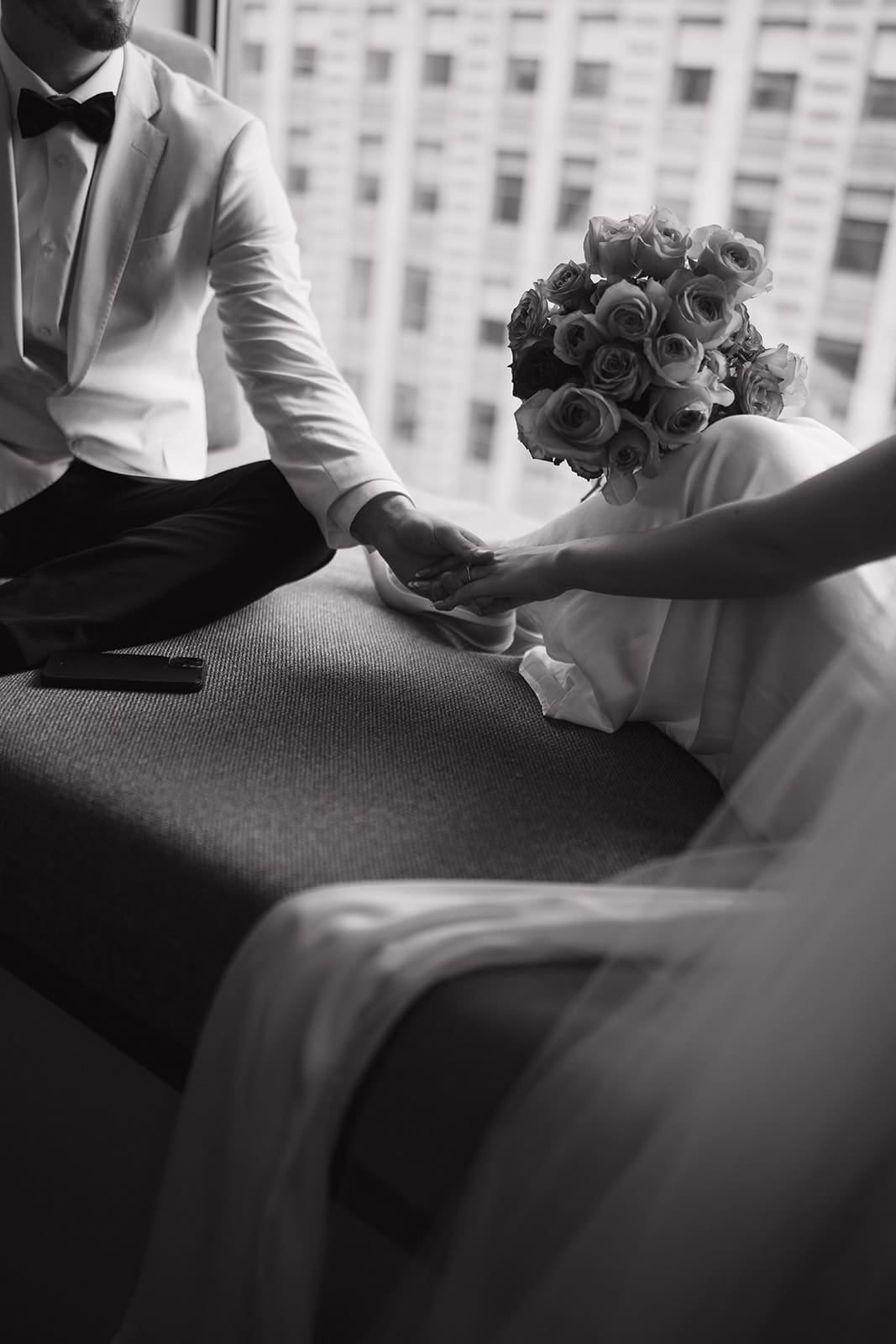 A bride and groom sharing private vows in a hotel room in photos taken by a Chicago wedding photographer