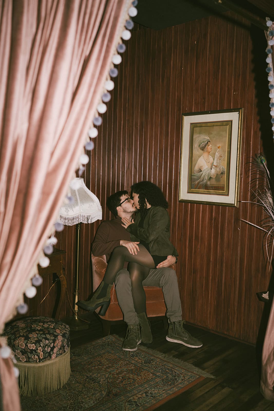 A couple kissing during their indoor engagement photos