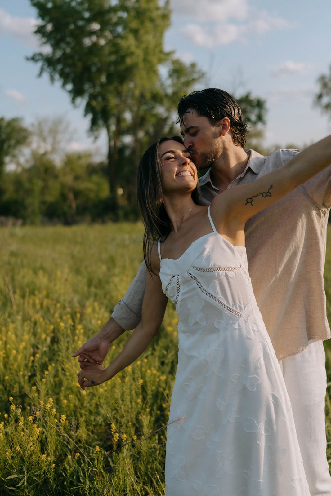 A couple posing for their outdoor engagement photoshoot