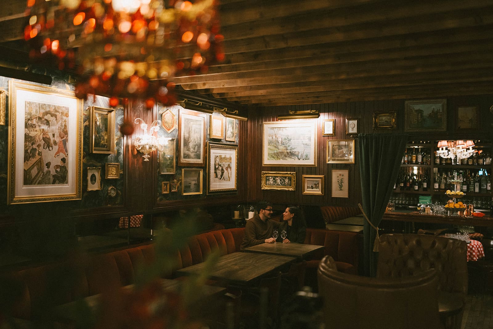 A couple at a bar for their winter engagement photoshoot