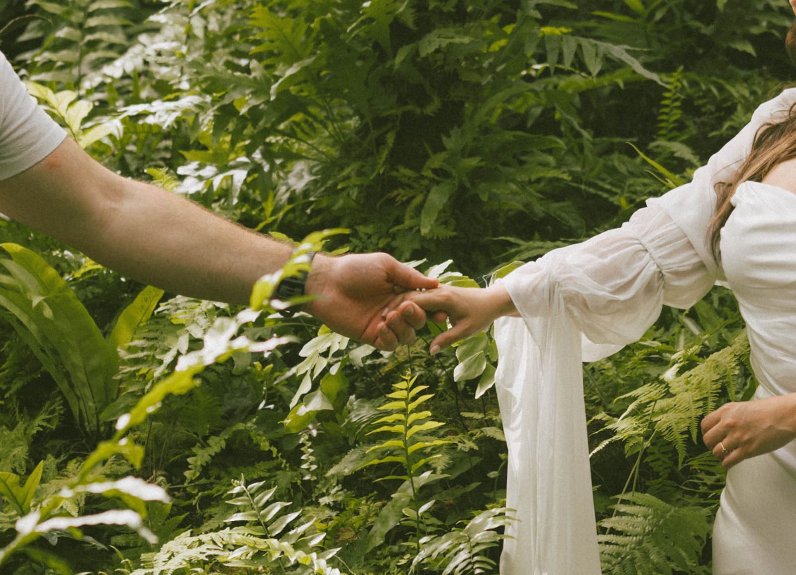 A couple holding hands during their engagement photoshoot