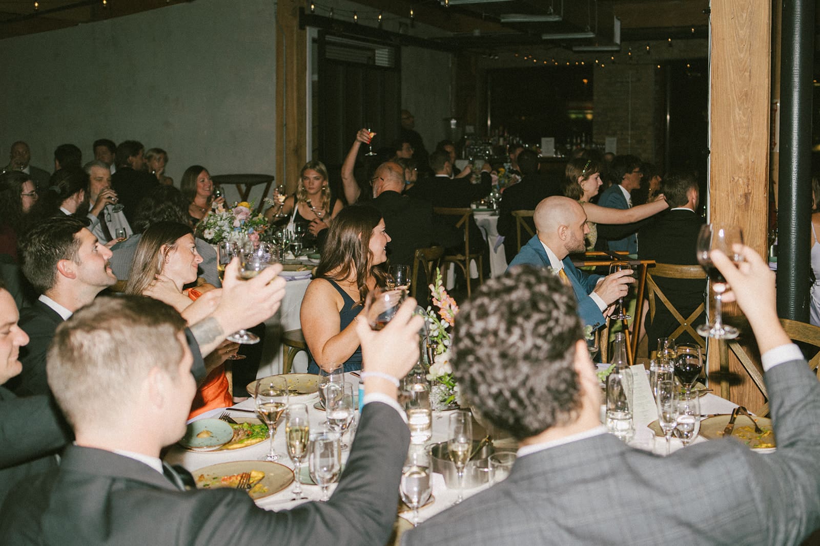 Wedding guests raising their glasses for a toast