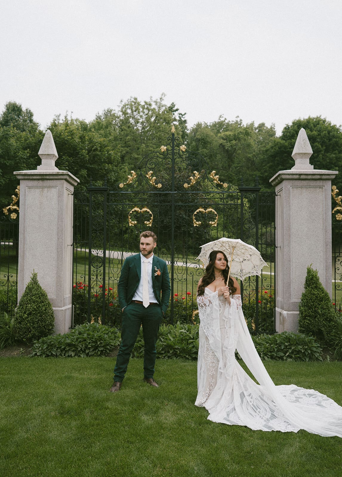 A couple posing for their fall Chicago wedding with a lace umbrella