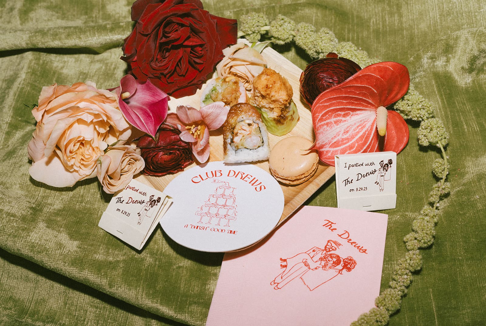 A wedding flat lay with sushi, wedding favors, and flowers