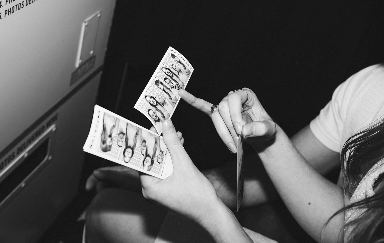A couple looking at their photo booth pictures
