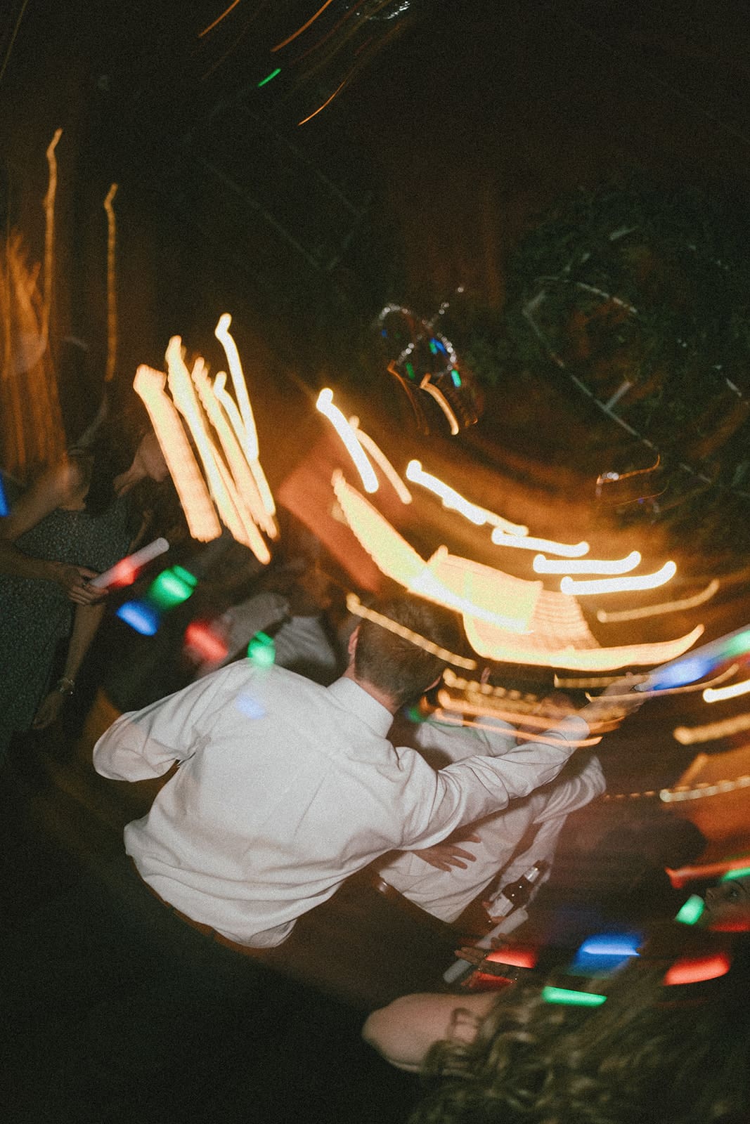 A candid wedding photo from a wedding reception dance floor