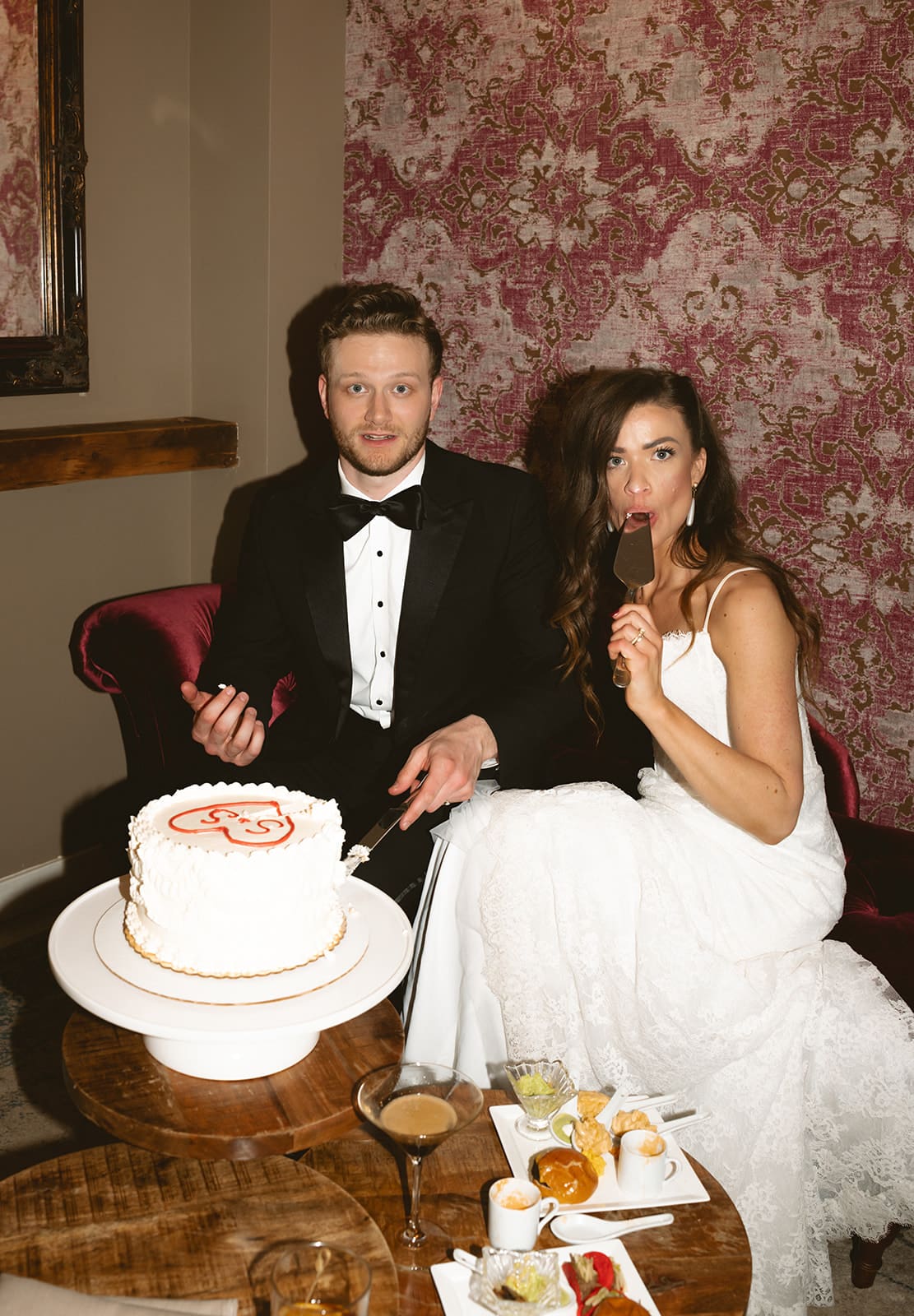 A bride and groom during a cake cutting at their wedding