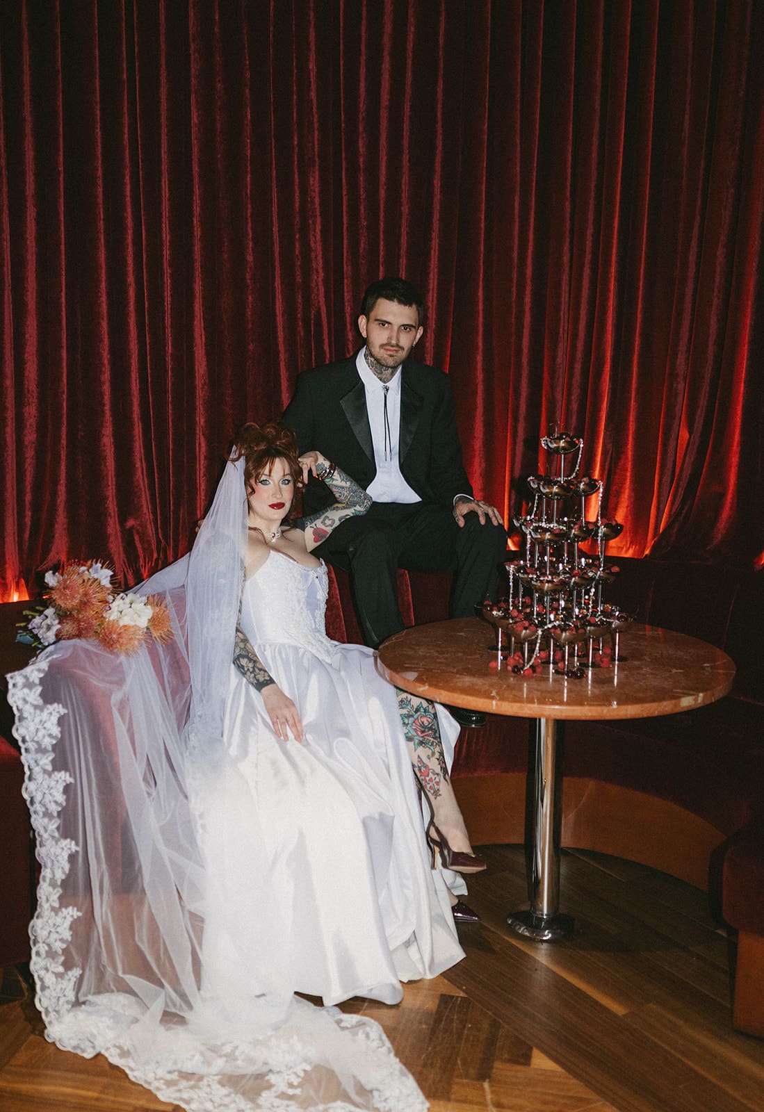 A bride and groom posing for unique wedding photos in a bar