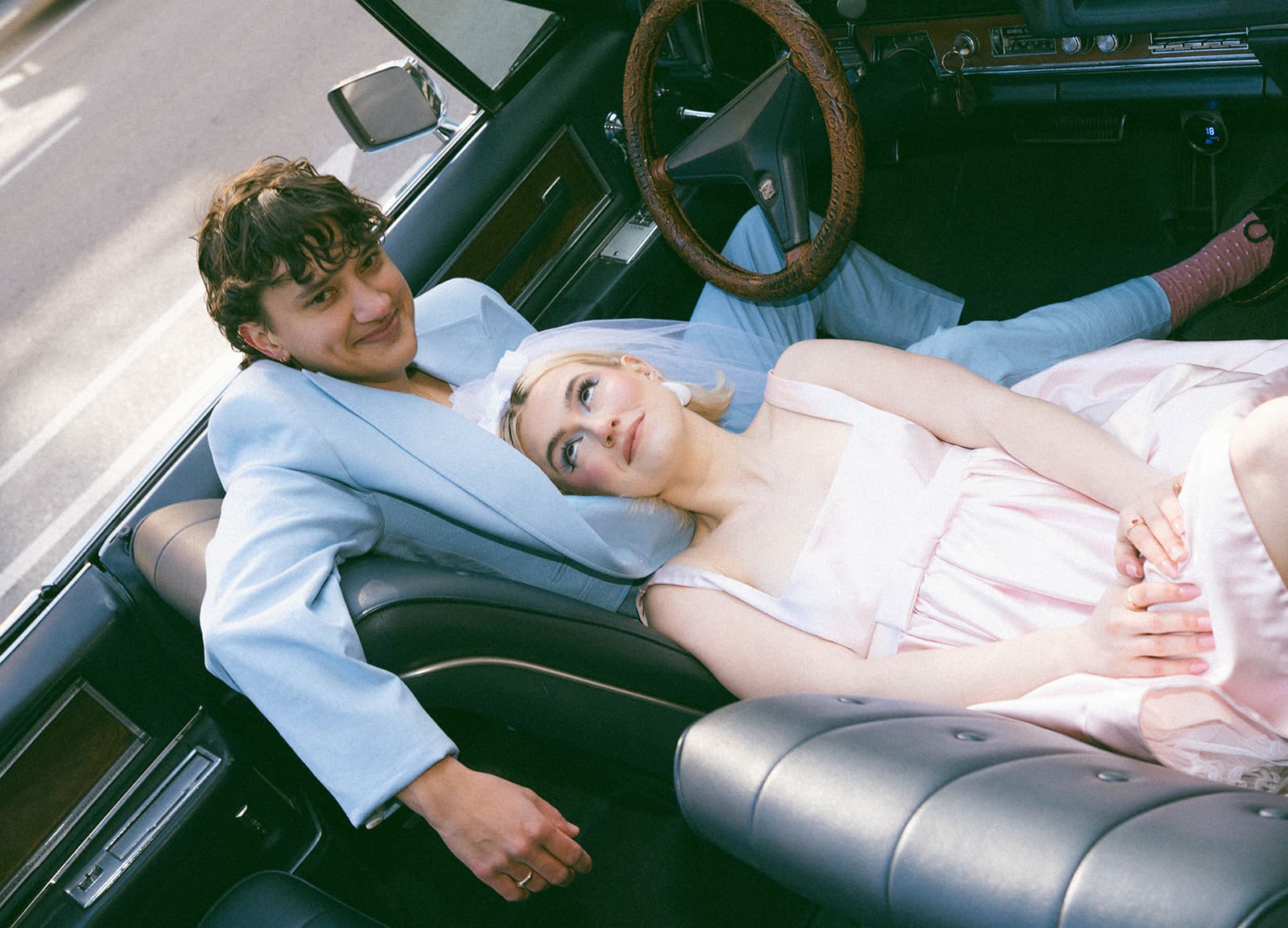 A bride and groom in a vintage car for unique Chicago wedding photos