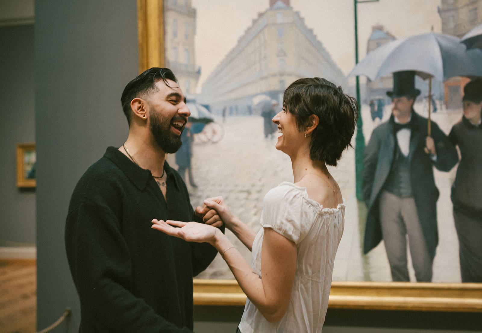 A couple laughing after their proposal with tons of proposal ideas