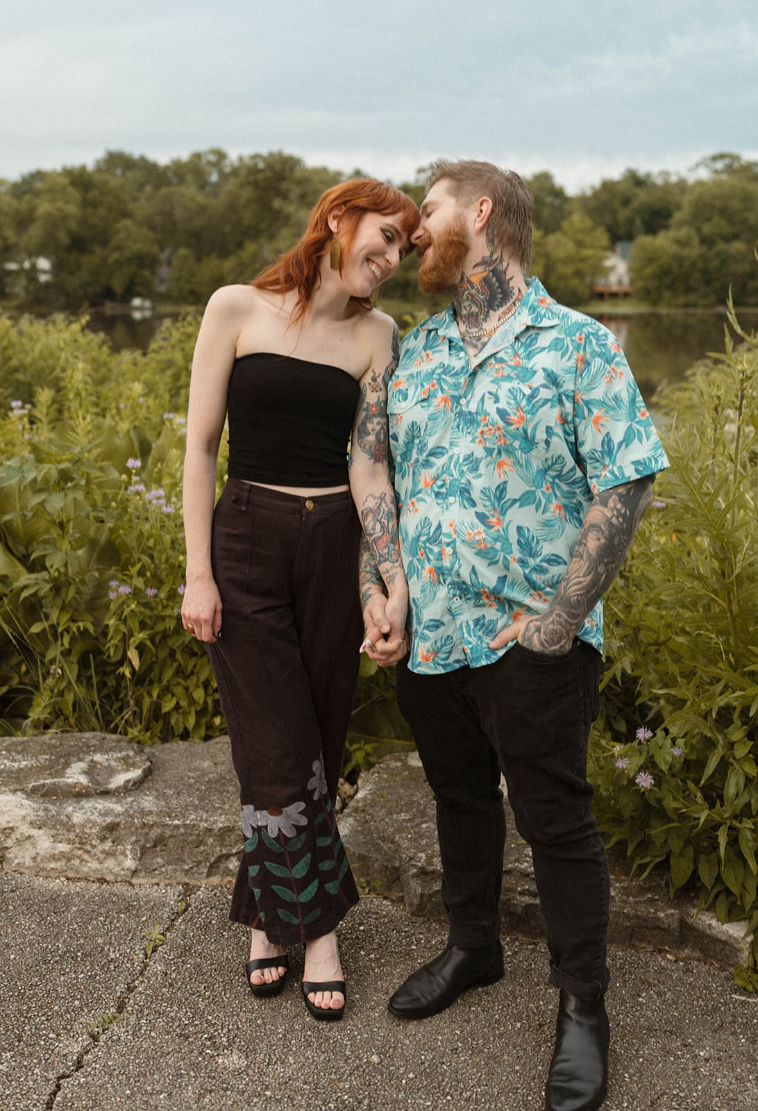 A couple posing for engagement photos outside