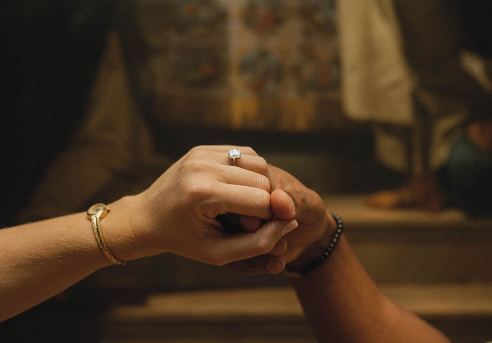 A couple holding hands after their proposal