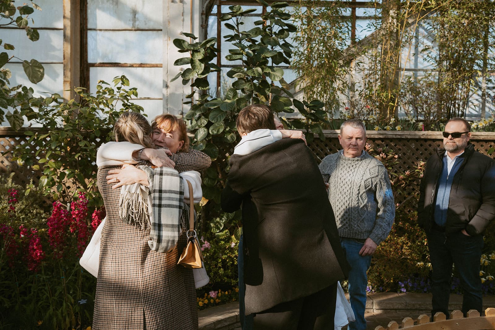 A couple hugging family after getting engaged as proposal ideas
