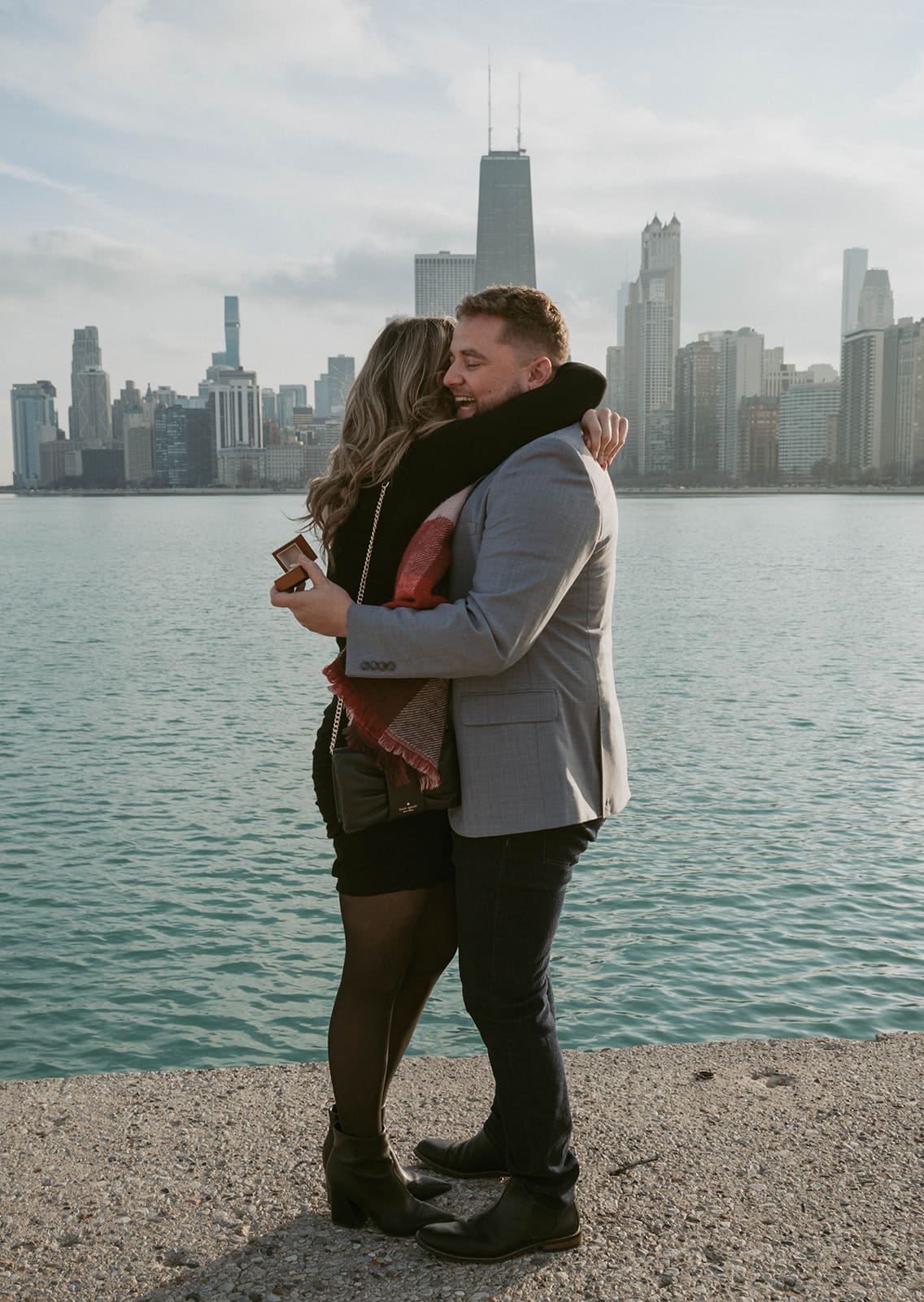 A couple hugging after a surprise proposal